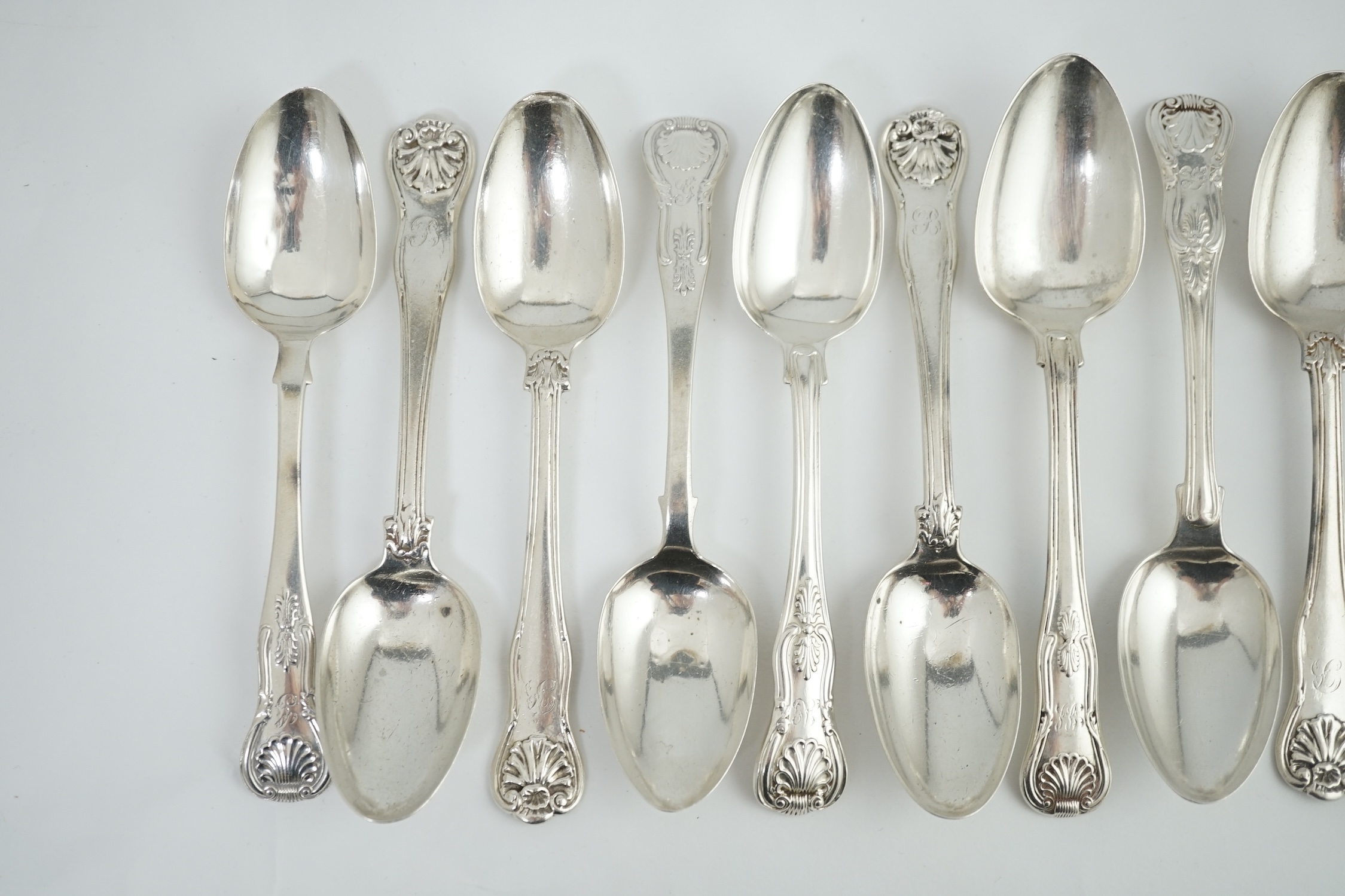 A harlequin set of twelve Georgian and Victorian silver Kings pattern dessert spoons, various dates and makers